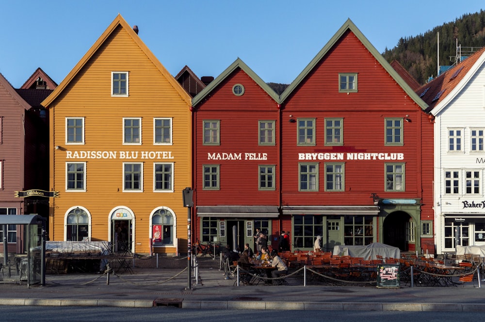 a row of red and yellow buildings sitting next to each other