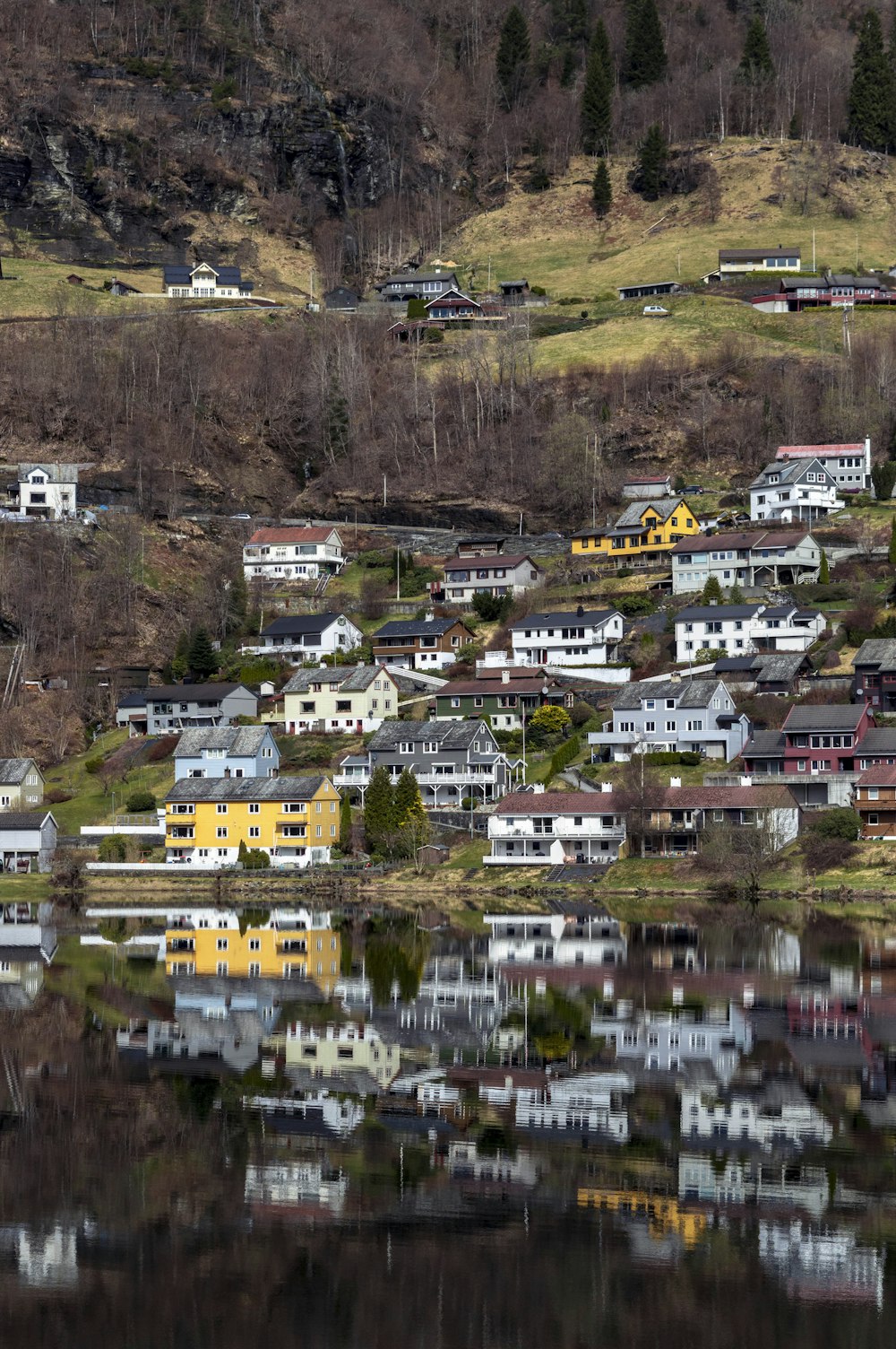 a small town on a hill next to a body of water