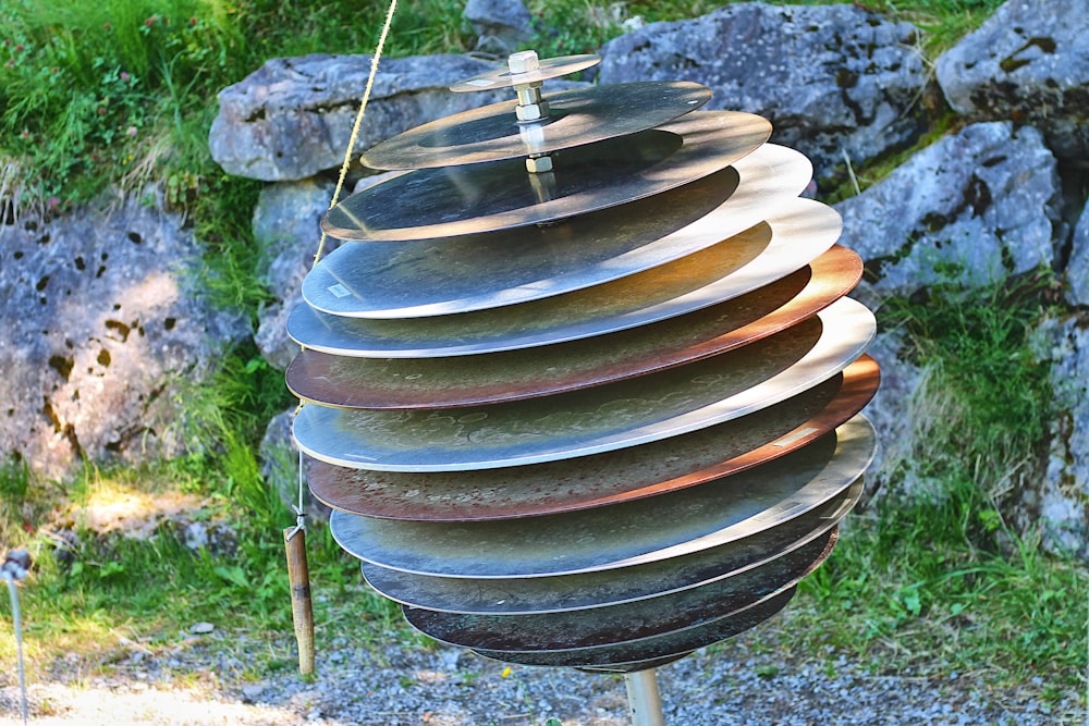 a wind chime in the middle of a grassy area