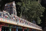 a colorfully painted temple with a mountain in the background