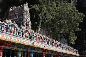 a colorfully painted temple with a mountain in the background