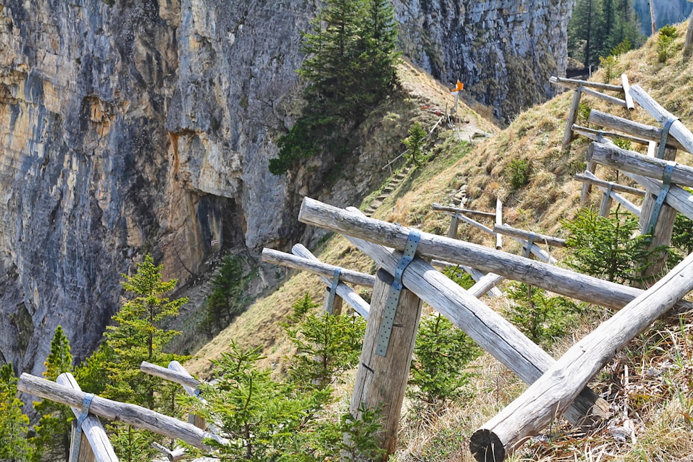 a wooden fence on the side of a mountain