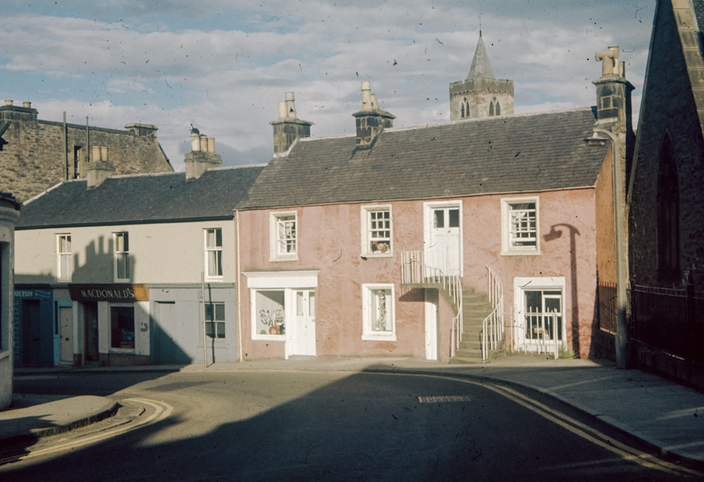 a row of houses on a street with a sky background