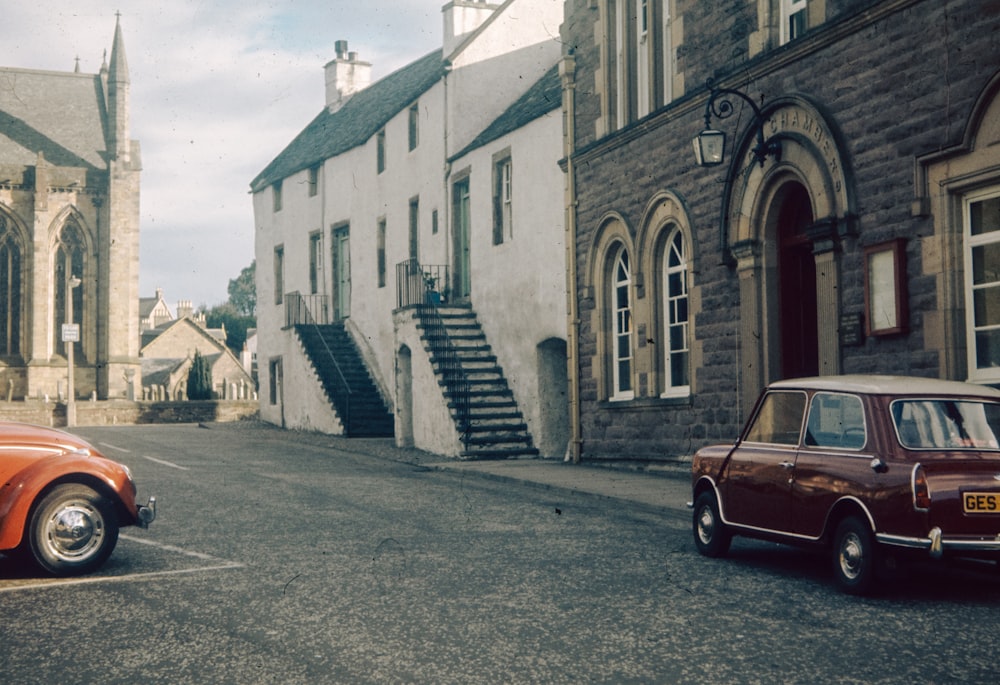 an orange car parked in front of a church