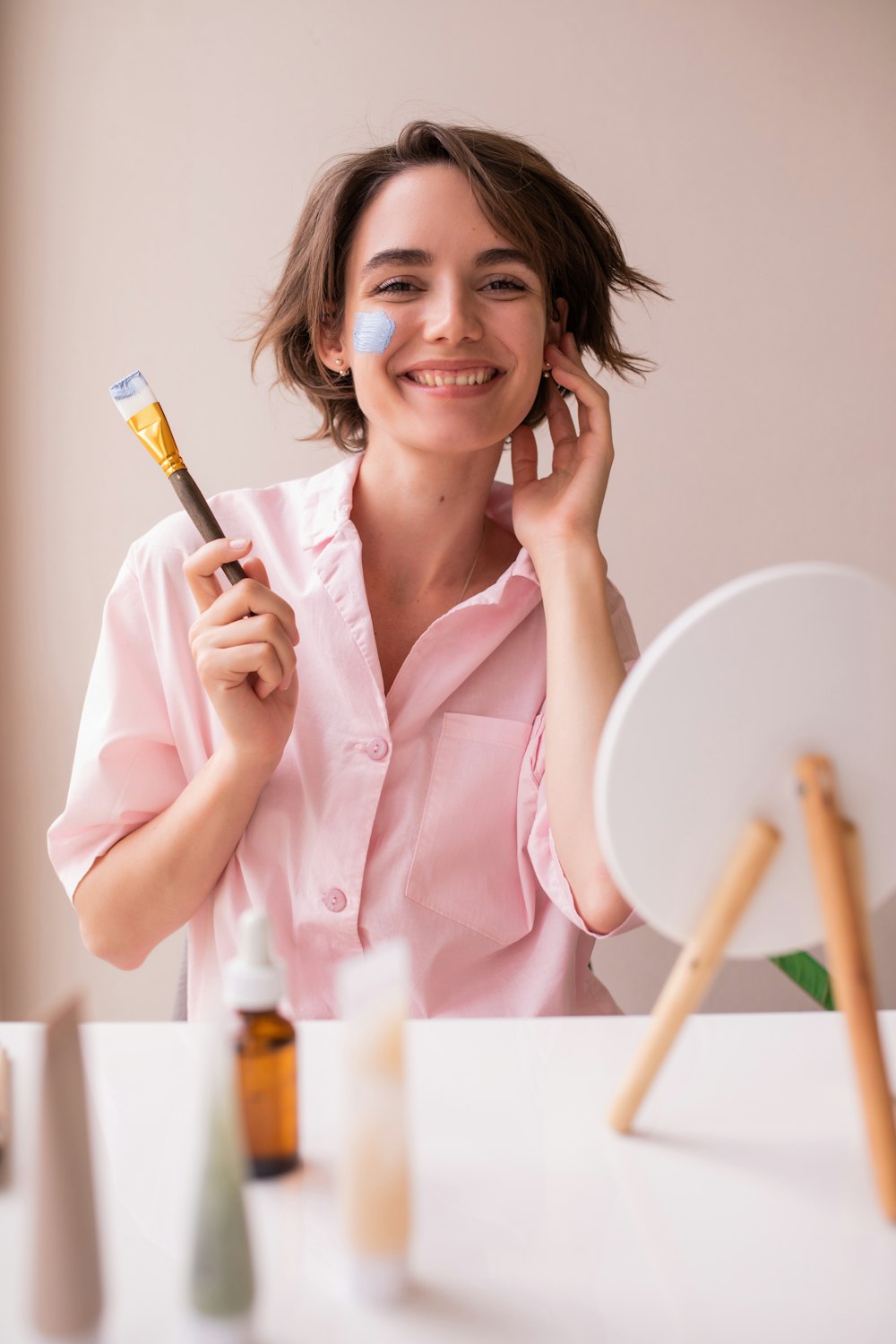 a woman is holding a brush and smiling