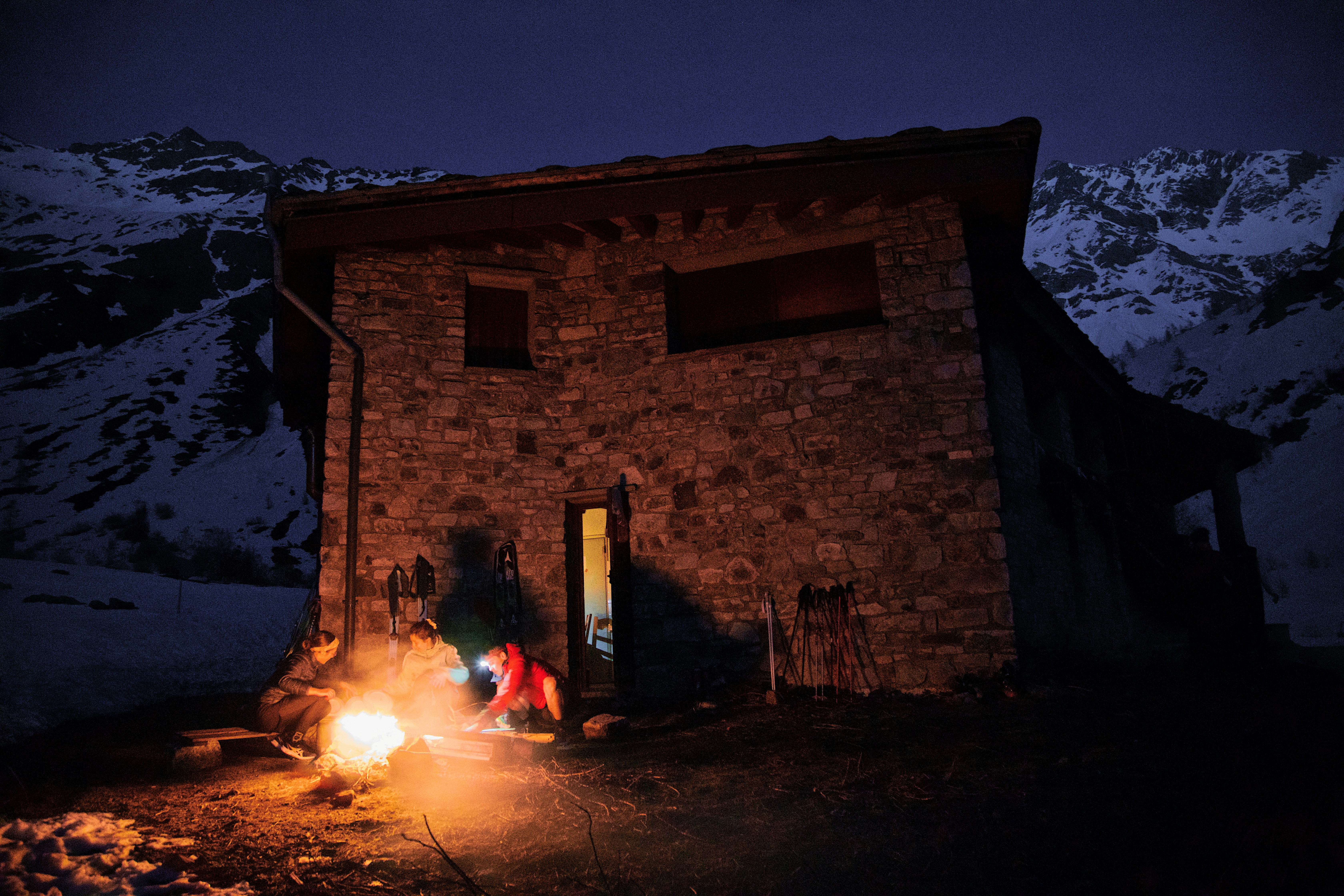 a couple of people standing next to a fire