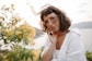 a woman in a white shirt talking on a cell phone