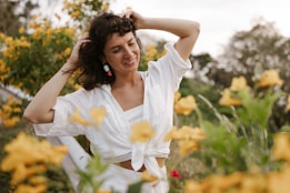 a woman standing in a field of yellow flowers