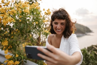 a woman holding a cell phone in her hand