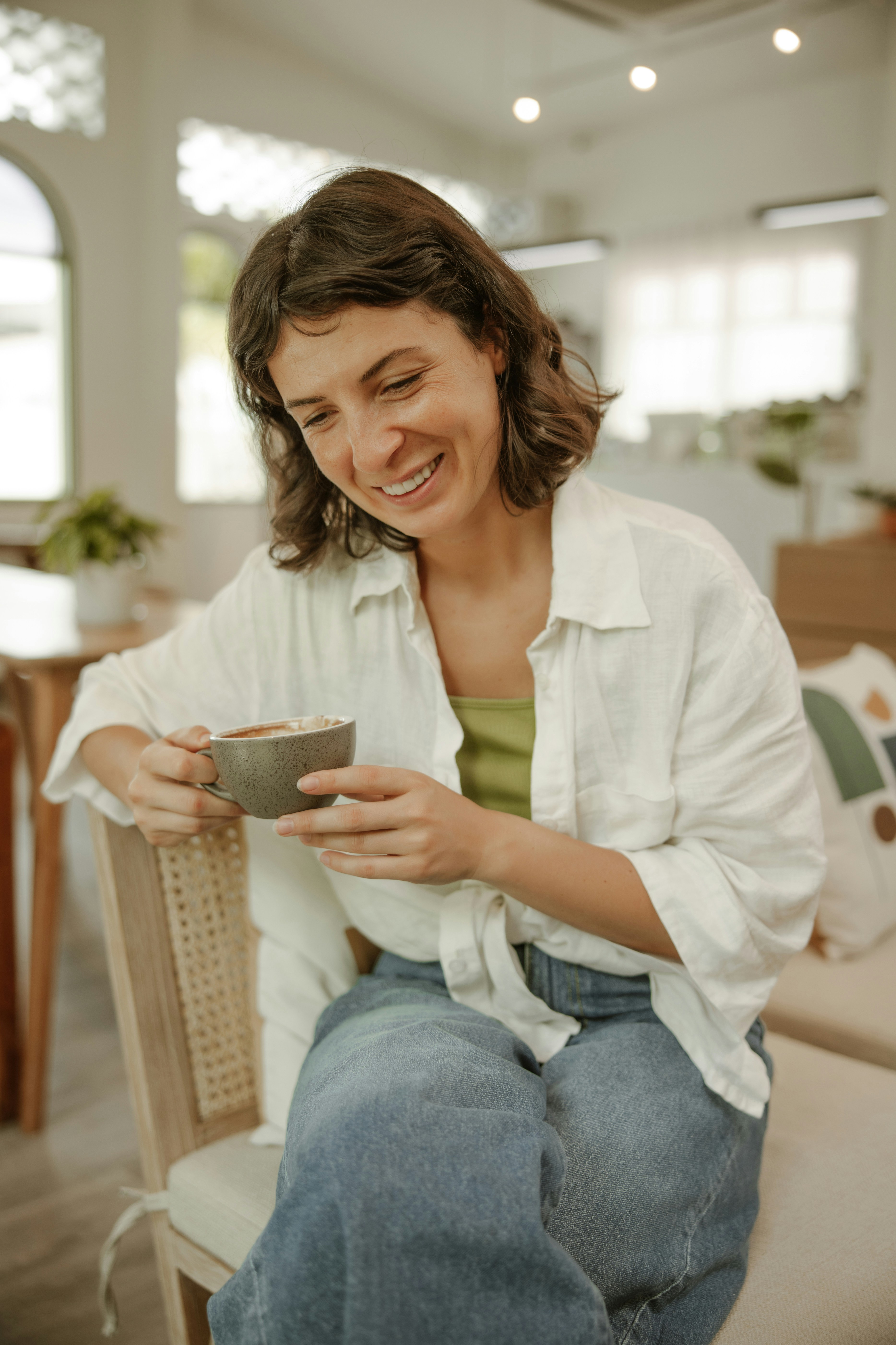 Image depicting a happy individual looking at a recovered crypto wallet on a laptop screen