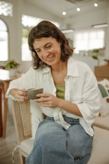 a woman sitting on a chair holding a bowl of food