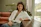 a woman sitting at a table with a laptop computer