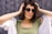 a woman wearing sunglasses and a green shirt