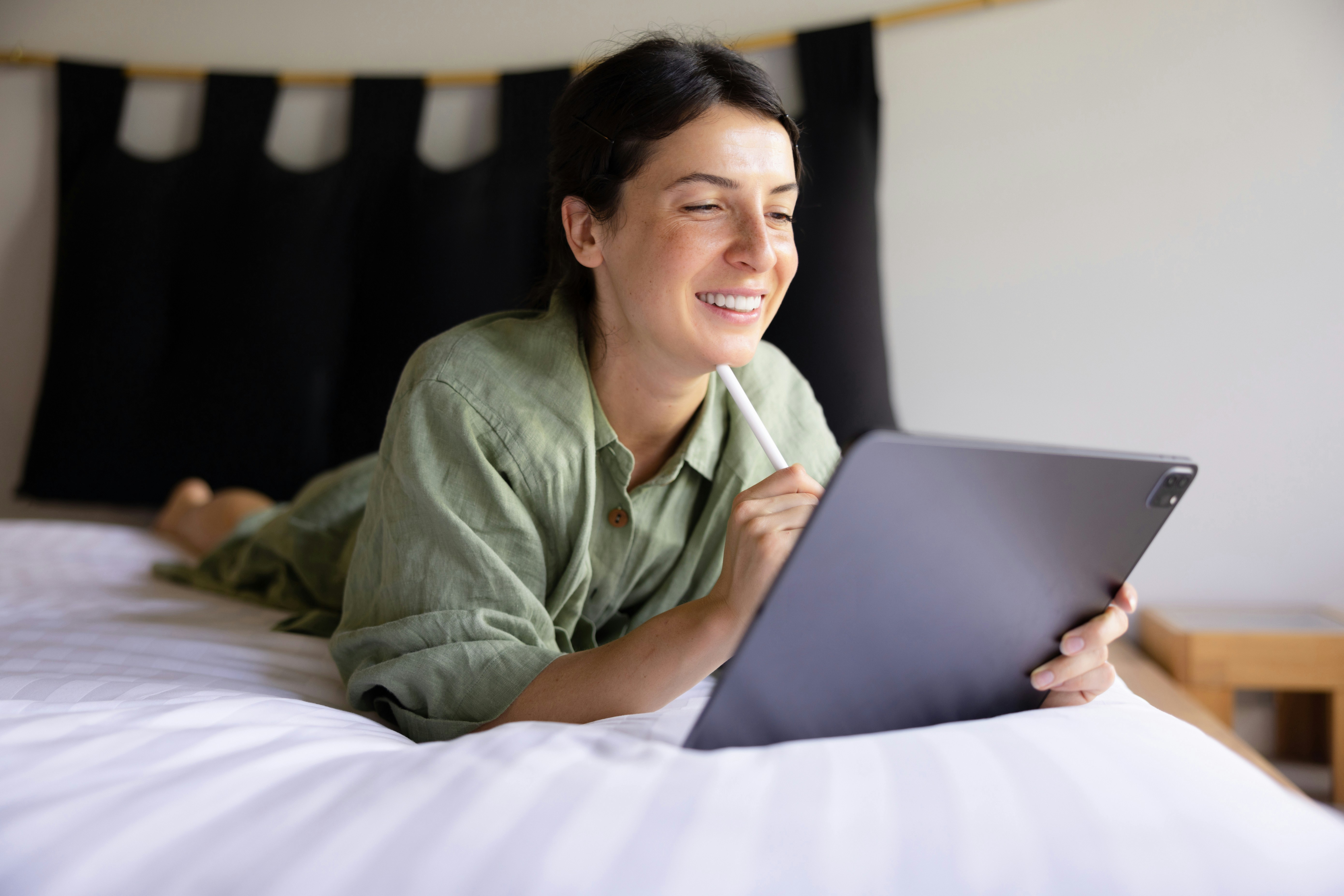 A hotel housekeeper using a digital checklist on a tablet
