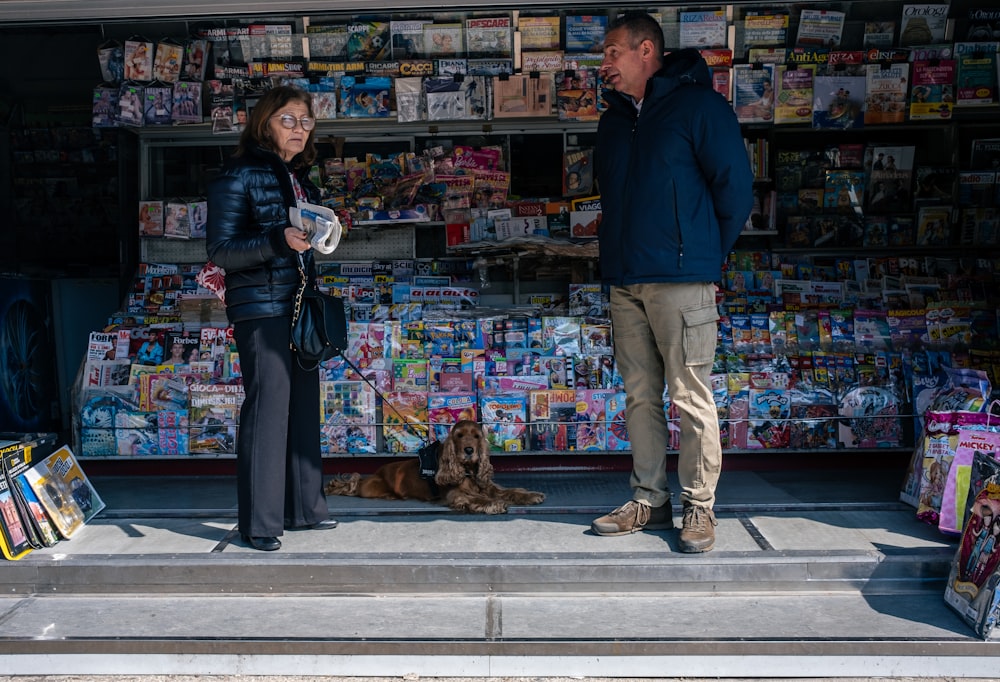 a man and a woman standing in front of a store