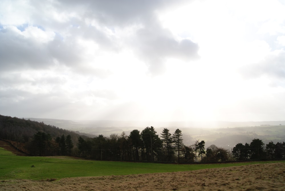 the sun shines through the clouds over the mountains