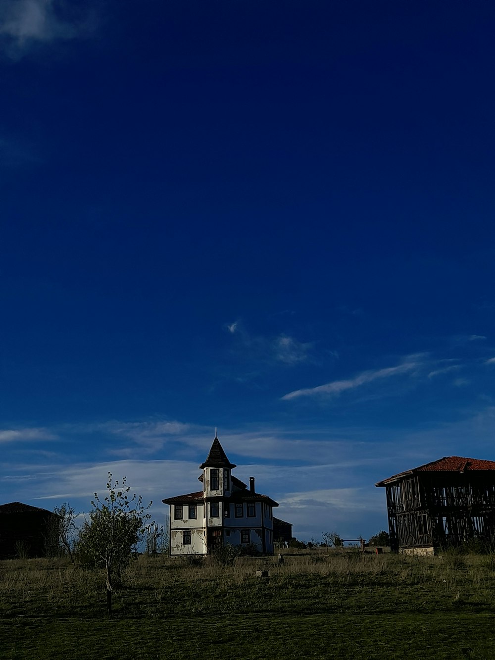 an old house in the middle of a field