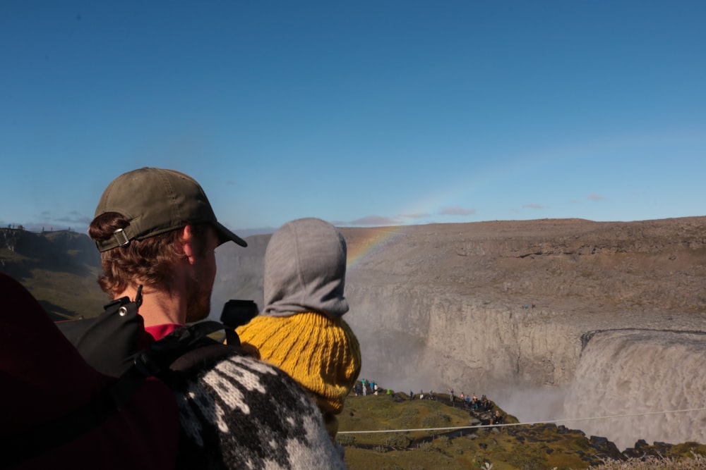 a man and a child looking at a rainbow