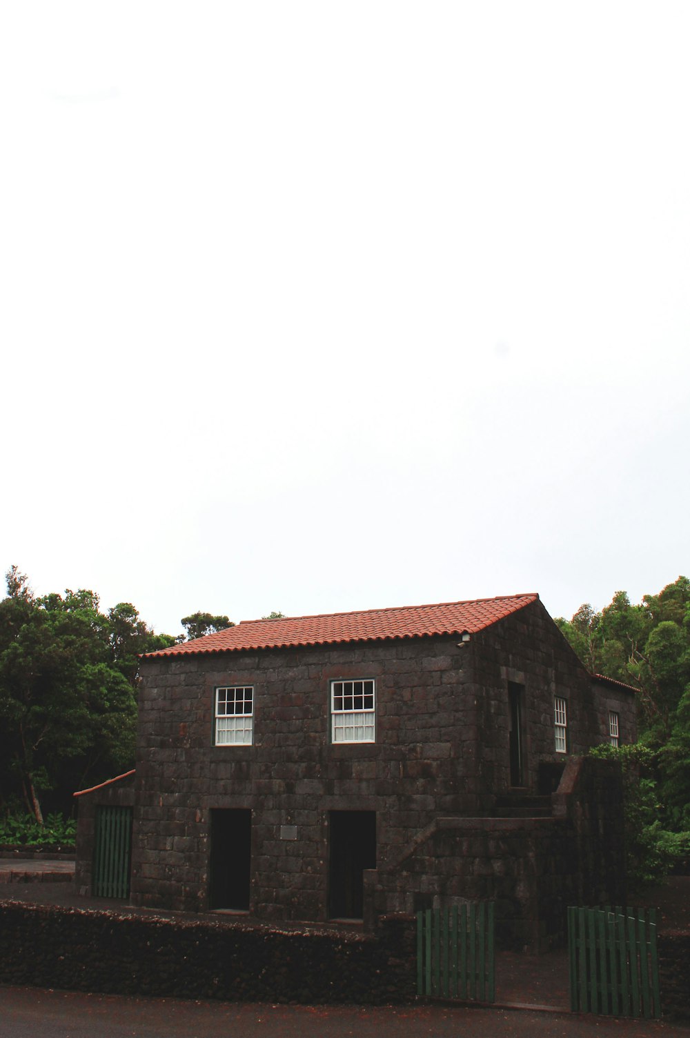 an old stone building with a red roof