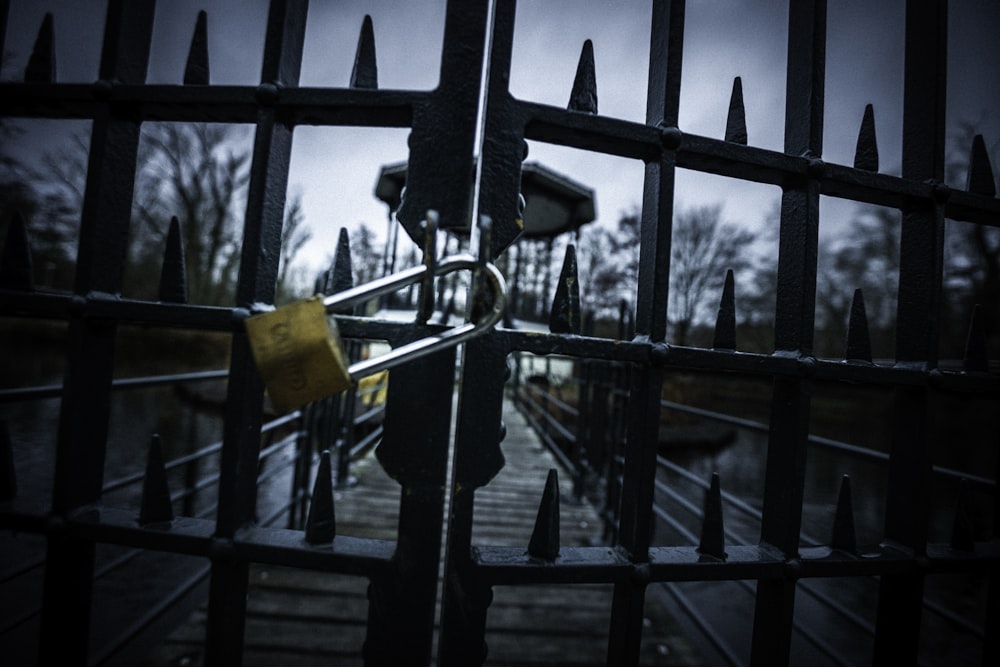 a gate with a yellow padlock on it