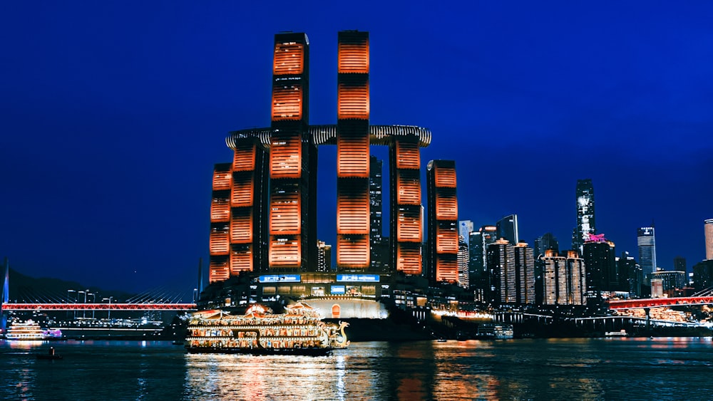 a large boat floating on top of a river next to a tall building