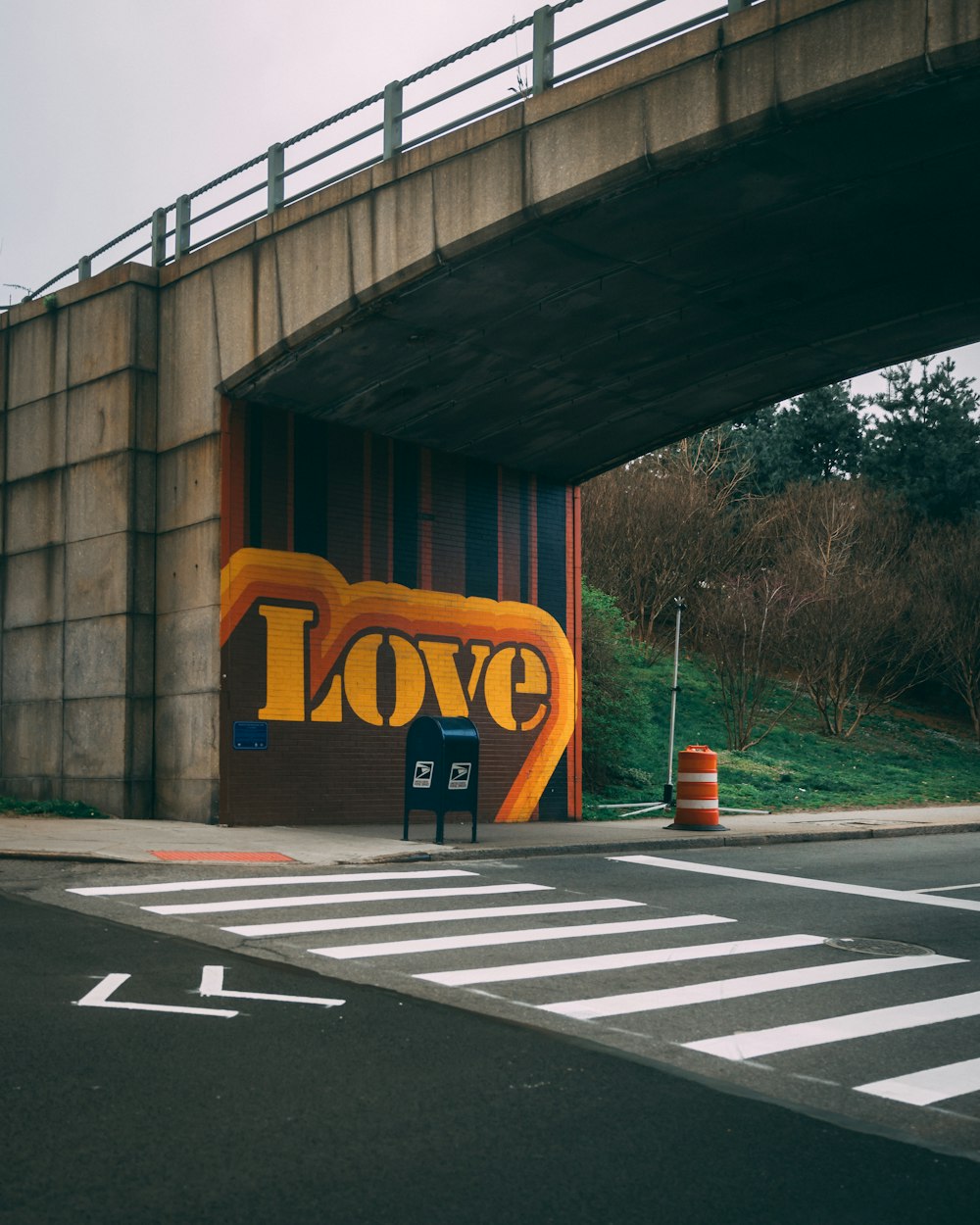 a street scene with focus on a wall with the word love painted on it