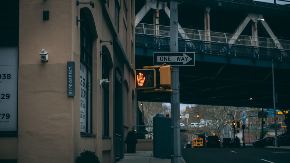 a traffic light on a city street next to a bridge