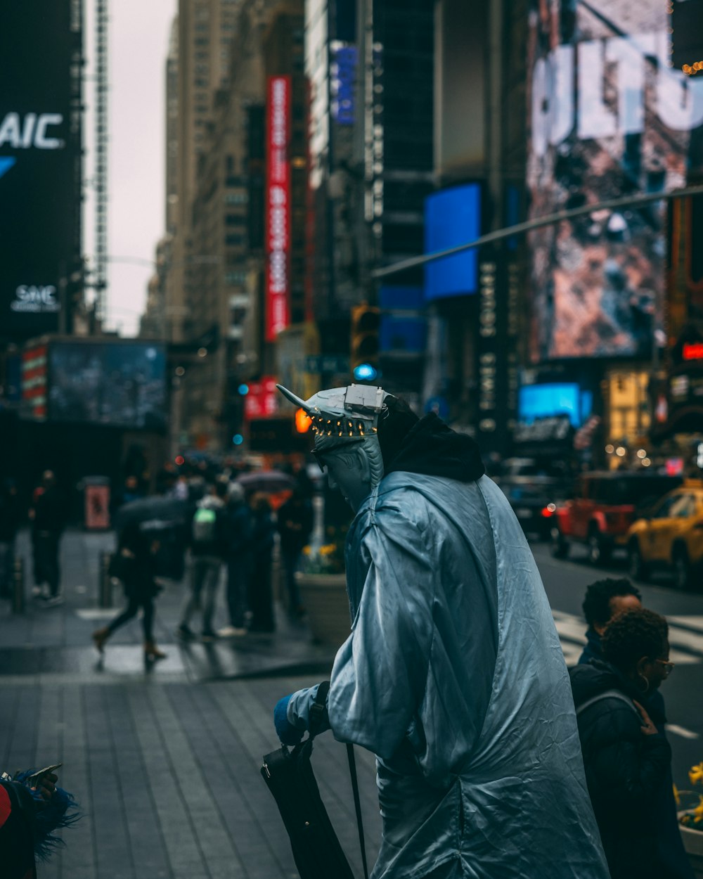 a man in a raincoat is walking down the street