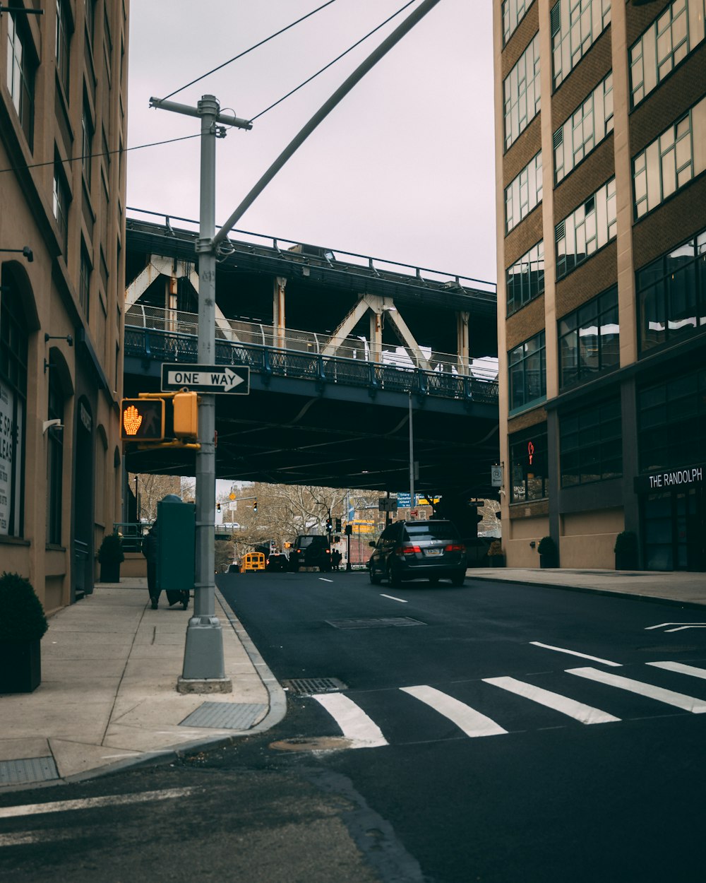 a city street with a bridge over it