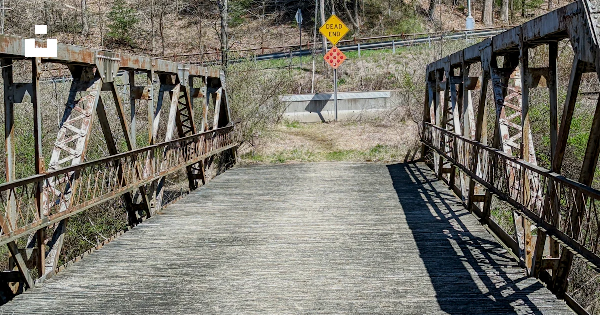 Rustic Public Bridge Sign An old rusty bridge with a yellow sign on it photo – Free Bridge Image ...