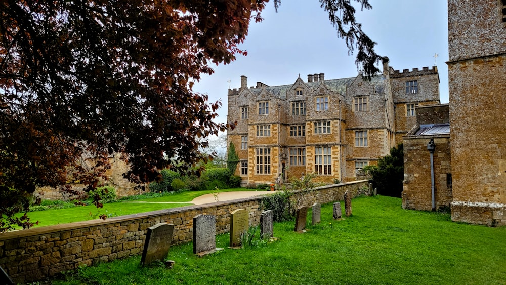 a large building with a green lawn in front of it