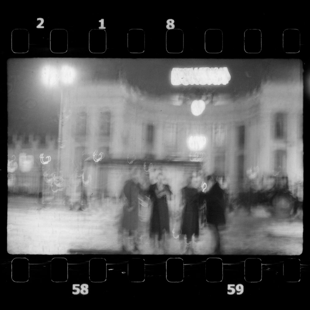 a group of people standing in front of a building