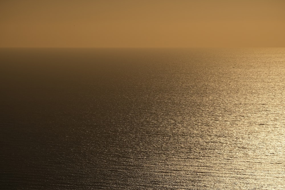 a large body of water sitting under a hazy sky