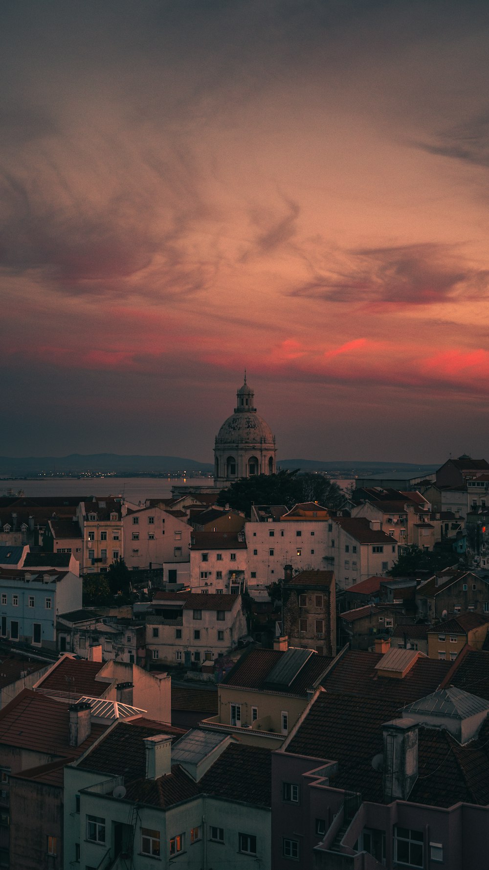 a sunset view of a city with a clock tower