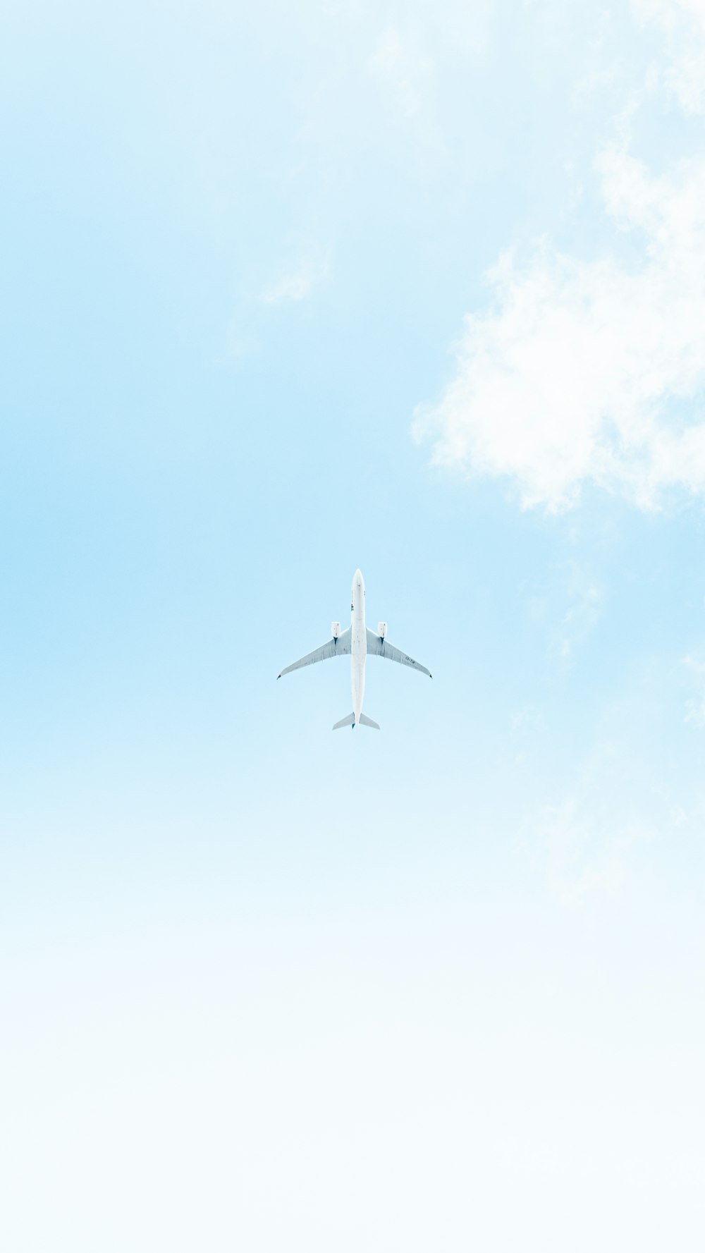 an airplane is flying in the blue sky