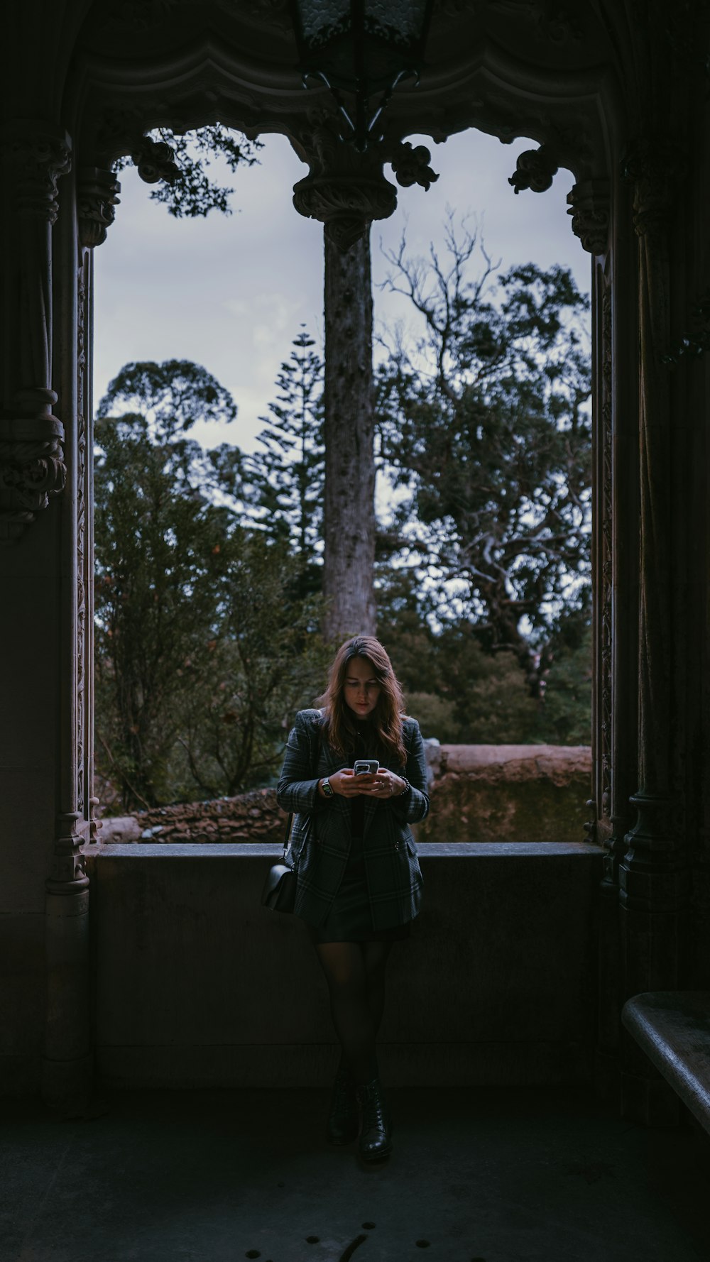 a woman standing in front of a window holding a plate of food