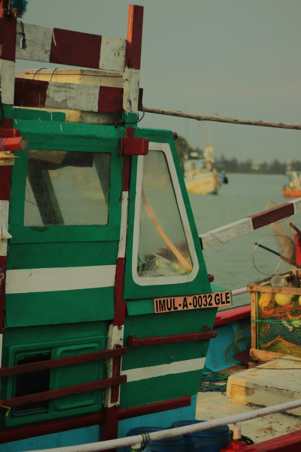 a green and white boat in a body of water