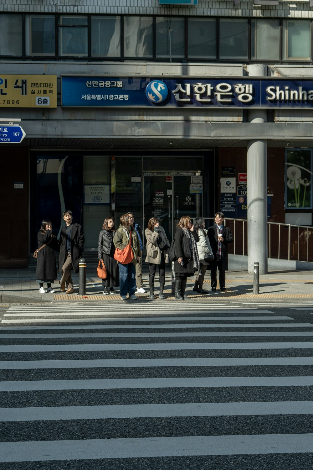 a group of people waiting to cross the street