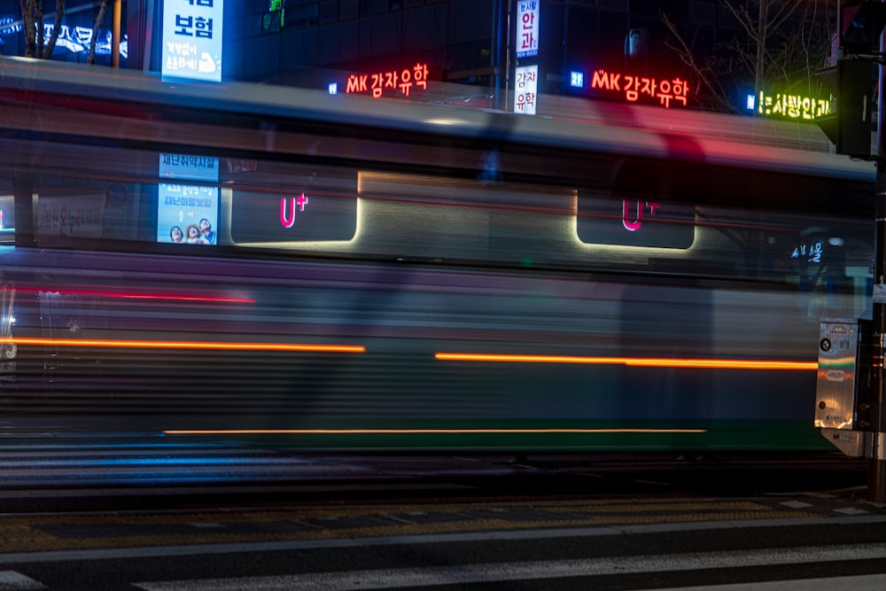 a city bus driving down a street at night