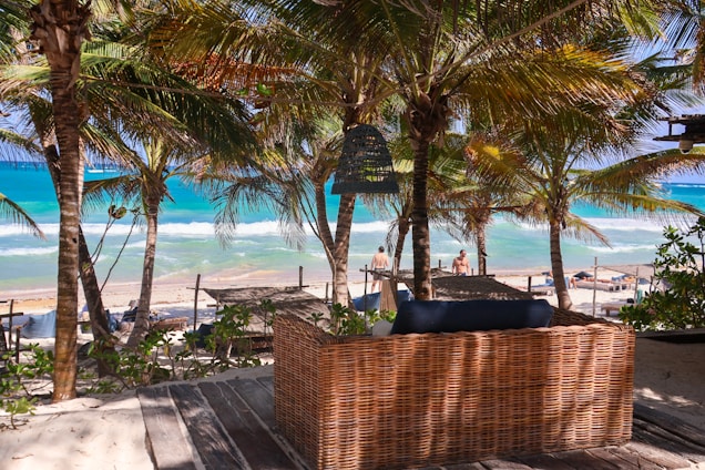 a wicker couch sitting on top of a wooden deck