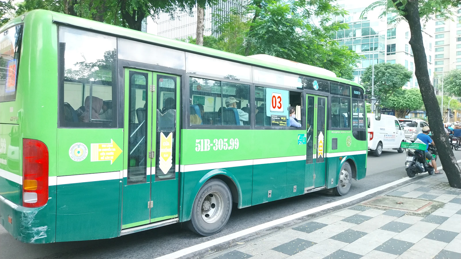 Green public bus travelling through Ho Chi Minh City, Vietnam