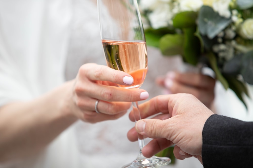 a bride and groom holding a glass of champagne