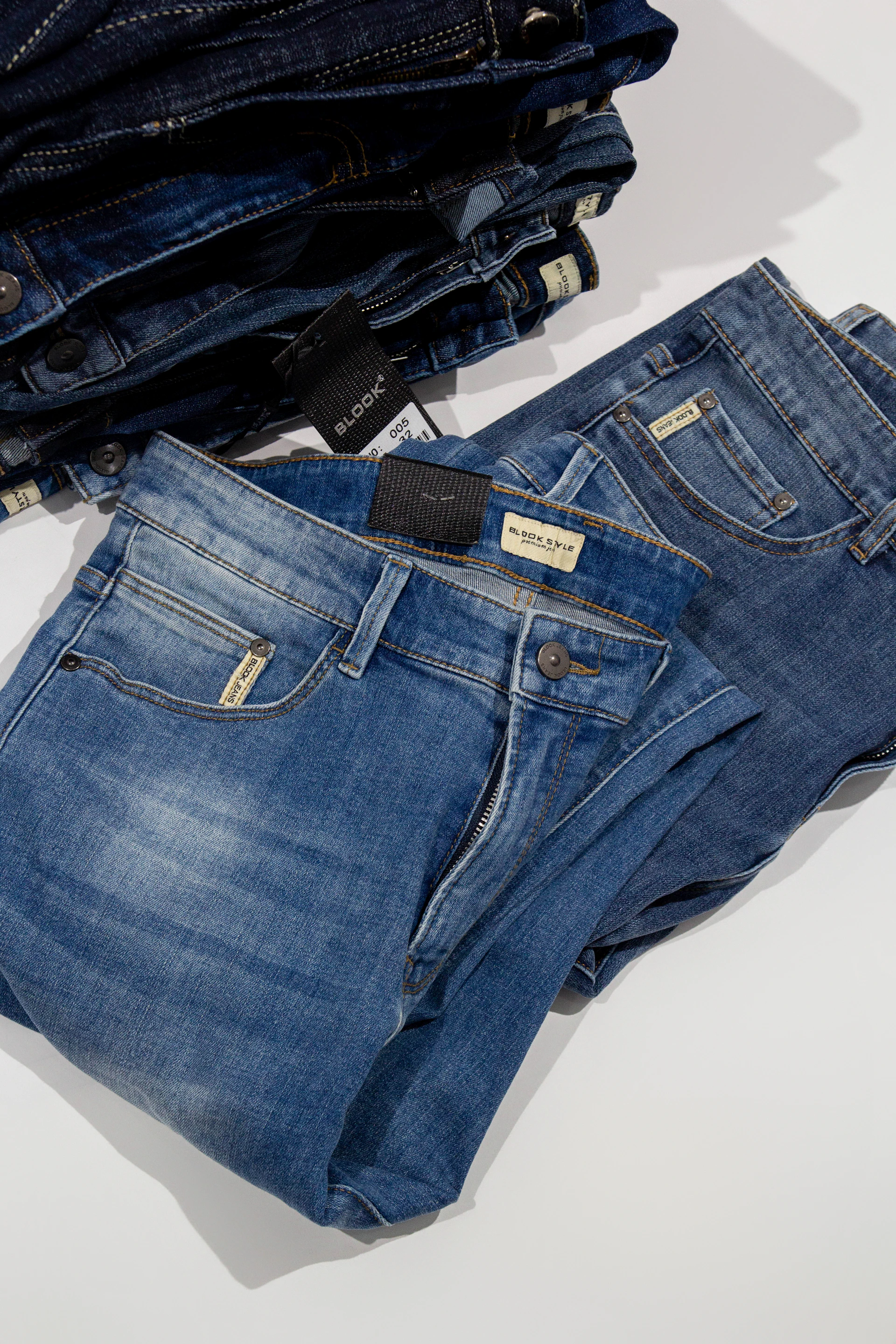 a pile of jeans sitting on top of a white table