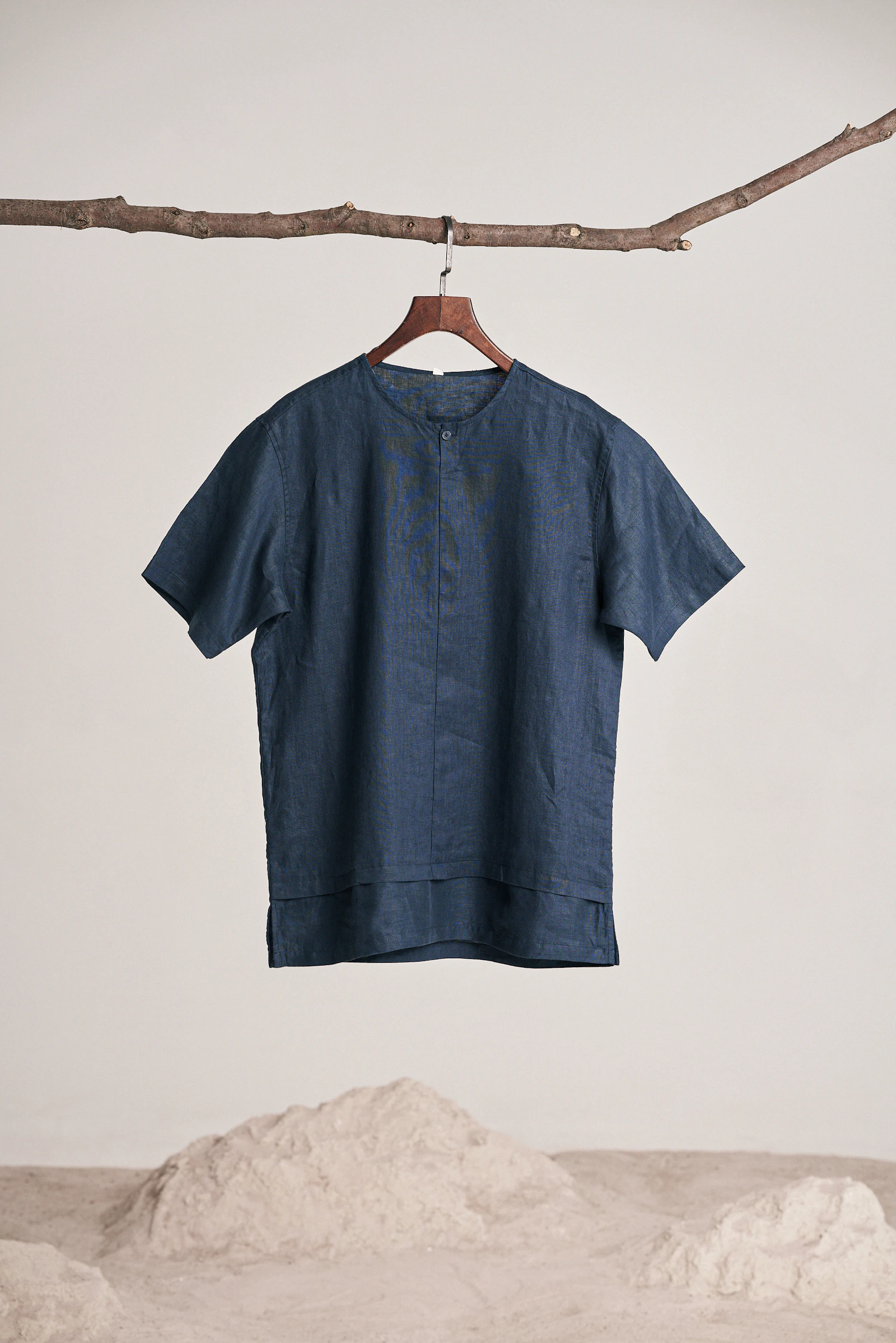 Navy short-sleeve linen shirt on hanger