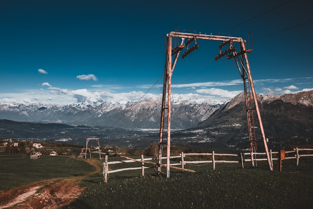 a wooden structure sitting on top of a lush green hillside