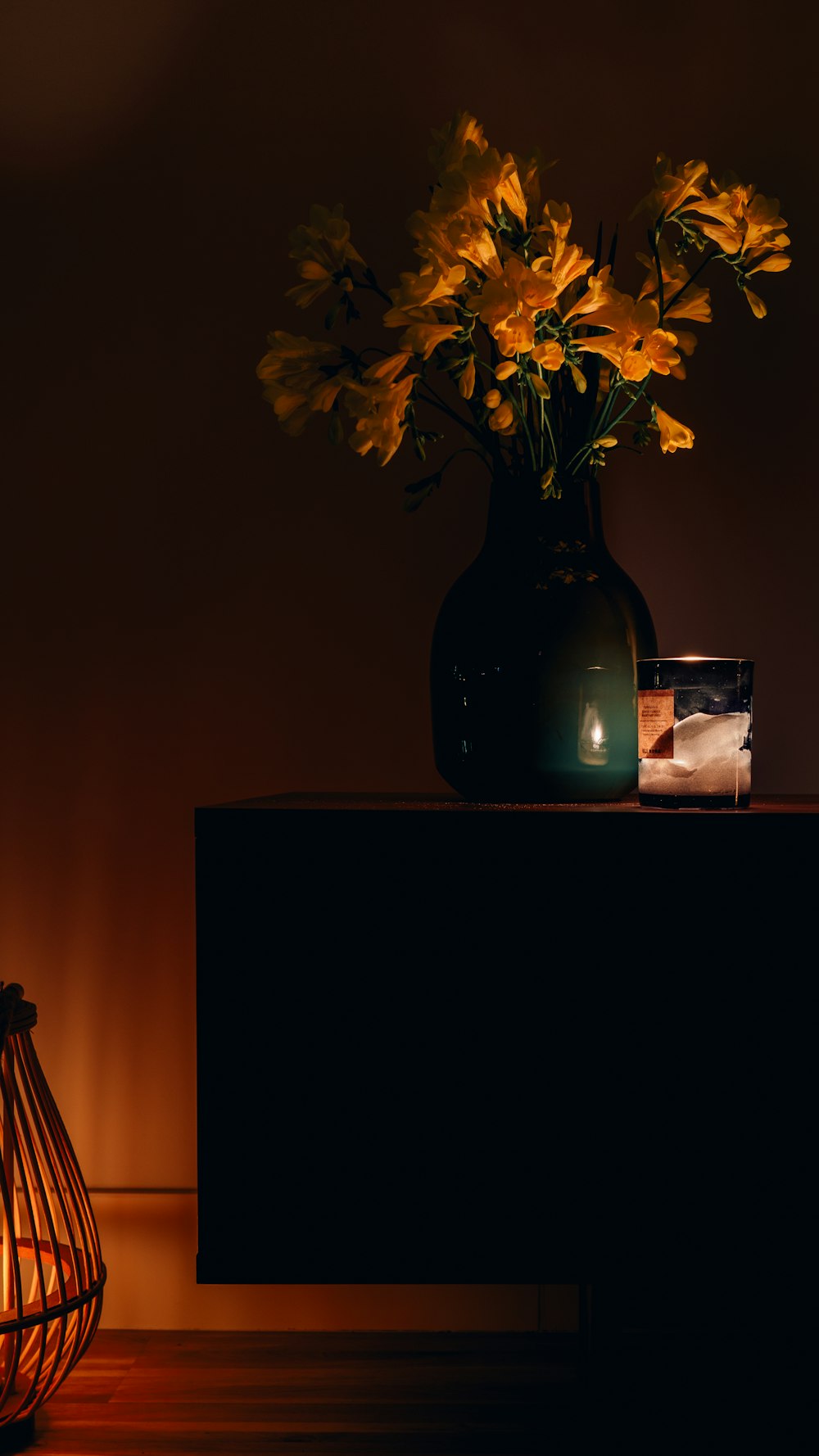 a vase with yellow flowers sitting on a table