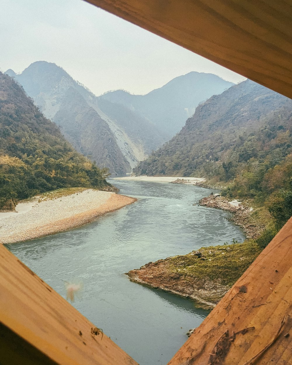 a view of a river and mountains from a window