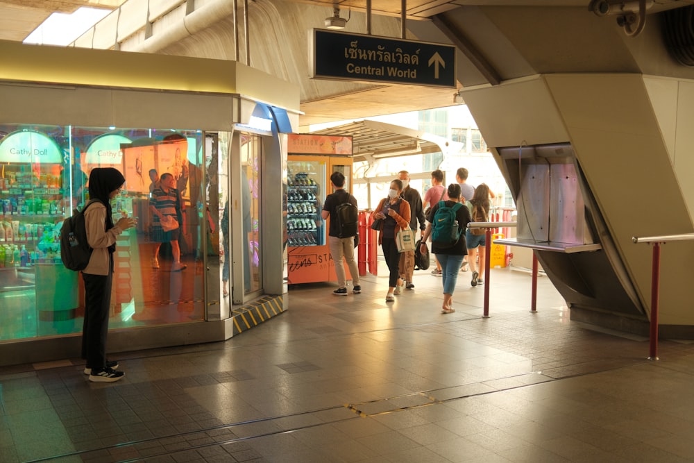 a group of people walking through a train station