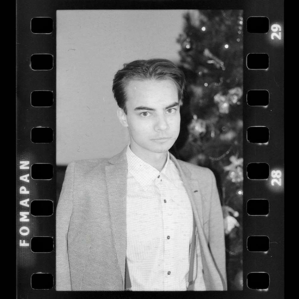 a black and white photo of a man in a suit