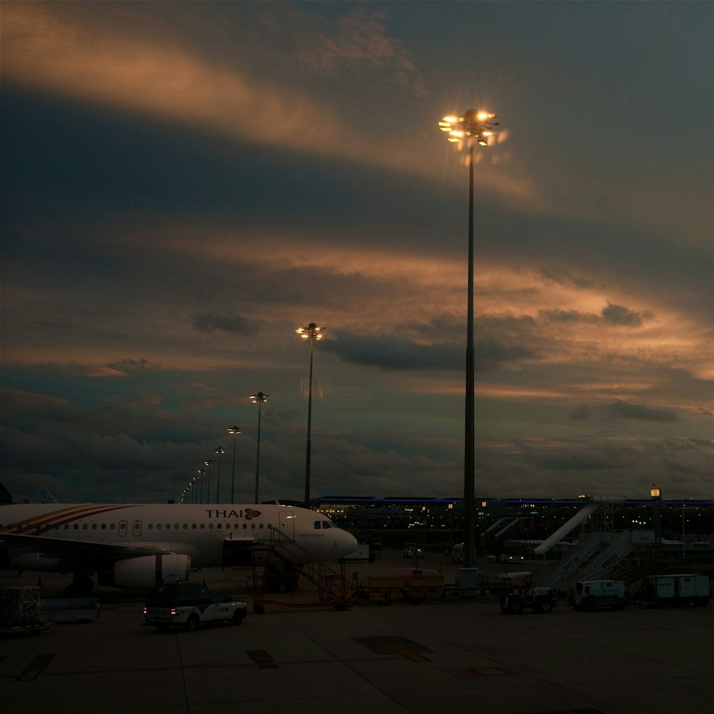an airplane is parked at an airport at dusk